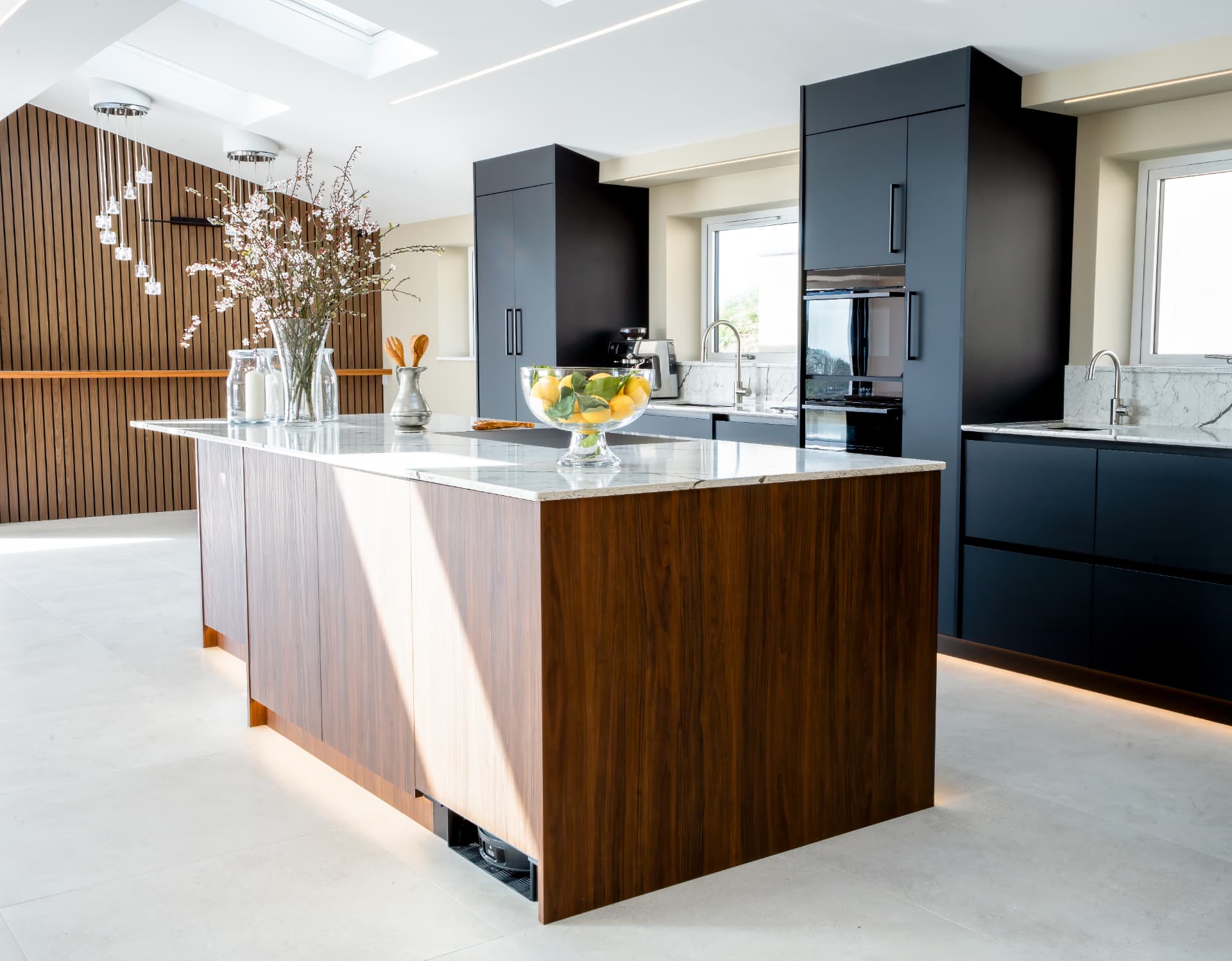 Bespoke olive green kitchen with stone island and brass detailing